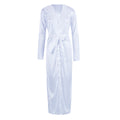 Product-only front view of the Seraphina  white satin-look long robe displayed against a white background, featuring smooth glossy white fabric, a deep V-shaped neckline with delicate lace-inspired edging, relaxed long sleeves, a matching white waist tie, and a flowing maxi-length silhouette with an overlapping wrap-style front.