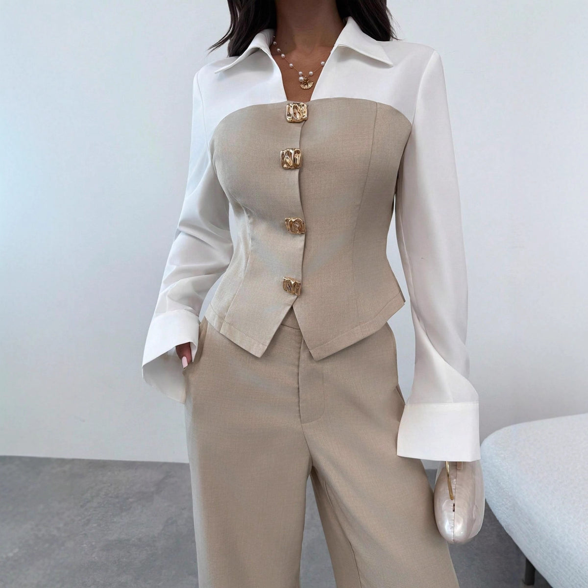 Close-up of the Sloane women's beige tailored vest and pants set, highlighting the V-neck button-front vest, fitted waist, coordinating beige trousers, and white collared blouse with long sleeves and wide flared cuffs.