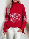Woman wearing a Red Snowfall Luxe Turtleneck Holiday Sweater with a white snowflake design on the front and sleeves, paired with white pants.
