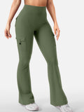 Talia women's army green high-waisted flare pants displayed on a model wearing a fitted cropped top and white athletic shoes, featuring a smooth high-rise waist, close-fitting stretch-style construction through the upper legs, decorative back pocket detailing, and flared lower legs extending toward the shoes.