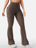 8359Talia women's coffee high-waisted flare active pants shown on a model, featuring a fitted upper silhouette, smooth brown fabric finish, subtle back pocket detailing, and full-length pant legs that widen below the knees for a trendy casual athleisure outfit.