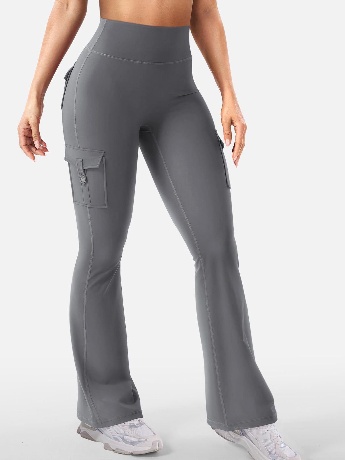 Talia women's gray high-waisted flare pants shown on a model, highlighting the fitted stretch-style fabric through the waist, hips, and thighs, smooth solid gray finish, decorative rear pocket construction, and gently widening lower pant legs.