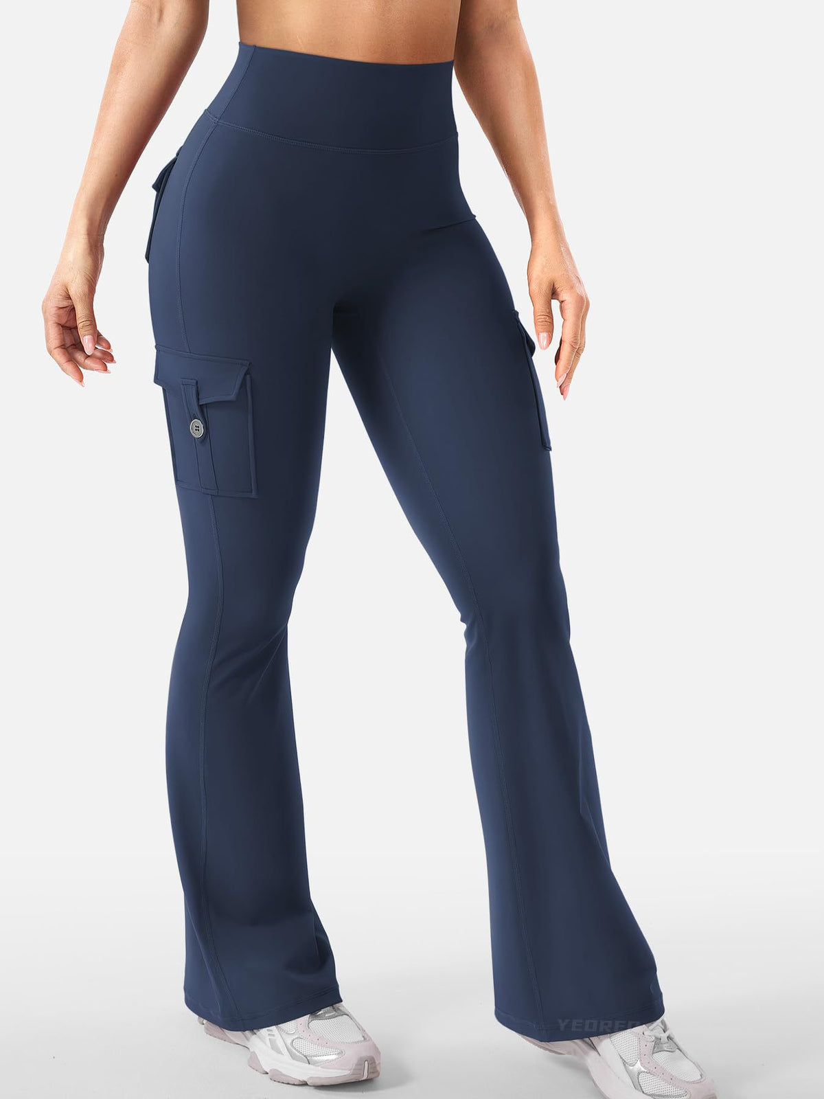 Talia women's navy blue flare active pants shown full length on a model, featuring a high-waisted fitted design, contoured shape through the hips and thighs, long legs widening toward the ankles, and a dark navy finish suitable for coordinated sporty and casual outfits.