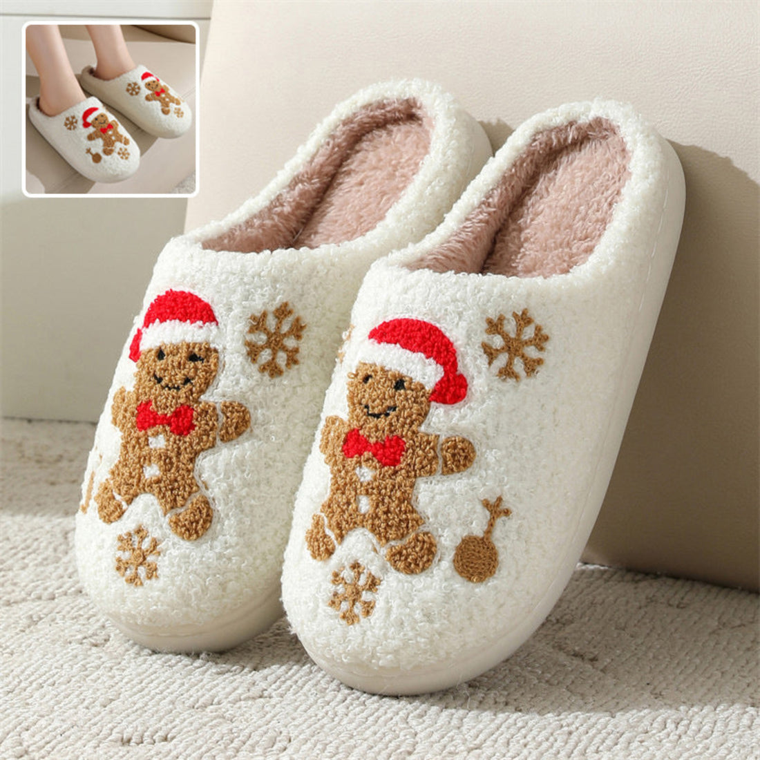 White women’s plush Christmas slippers featuring embroidered gingerbread characters wearing festive red holiday hats and scarves, brown snowflake accents, soft fuzzy closed-toe uppers, and cozy cream lining, displayed together from the front for a clear view of the gingerbread and winter-themed embroidery.