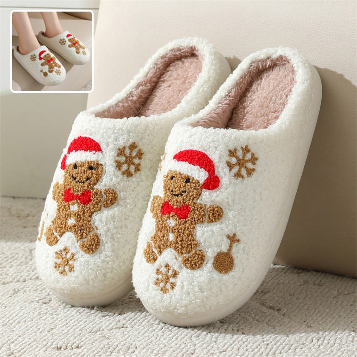 White women’s plush Christmas slippers featuring embroidered gingerbread characters wearing festive red holiday hats and scarves, brown snowflake accents, soft fuzzy closed-toe uppers, and cozy cream lining, displayed together from the front for a clear view of the gingerbread and winter-themed embroidery.