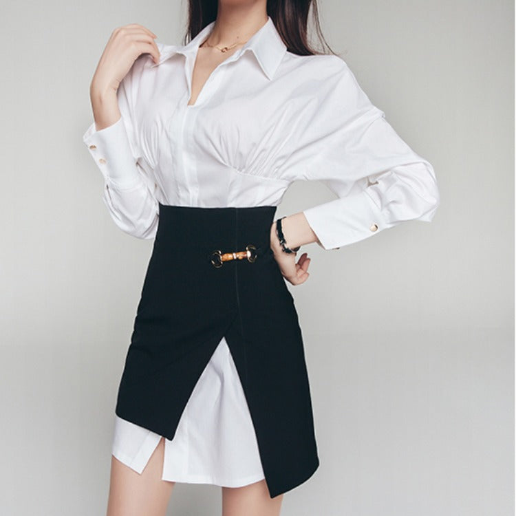 Woman wearing white long-sleeve shirt and high-waist black asymmetrical skirt set.