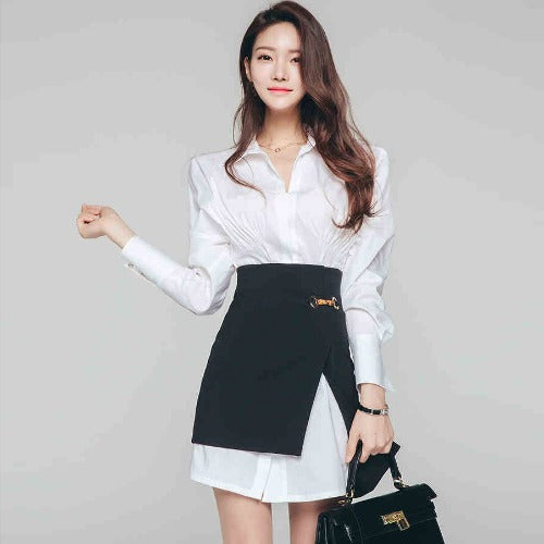 Front view of women's white shirt and black asymmetrical mini skirt set.