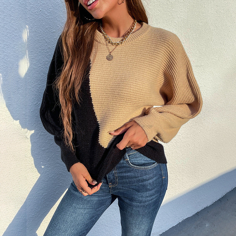 Woman wearing black and camel color-block knit sweater with long sleeves and blue jeans