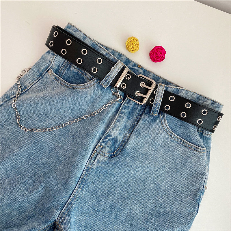 Women’s black double-row grommet chain belt styled with blue denim jeans