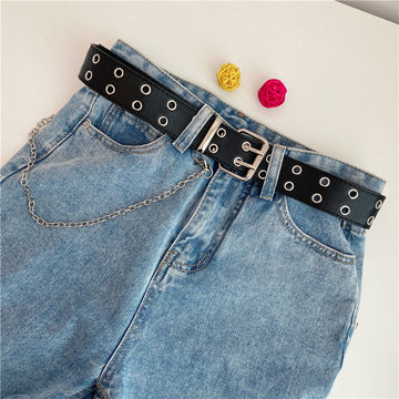 Women’s black double-row grommet chain belt styled with blue denim jeans