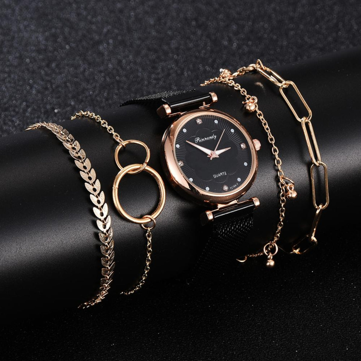 Women's black mesh watch with rose gold case and coordinating gold-tone bracelet jewelry set
