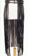 Women’s black statement waist belt with long flowing tassel fringe and silver-tone buckle details