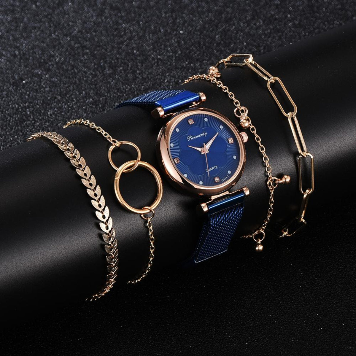 Women's blue mesh watch with rose gold case and coordinating gold-tone bracelet jewelry set