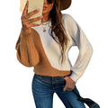 Woman modeling camel and cream color-block knit sweater with long sleeves and relaxed fit