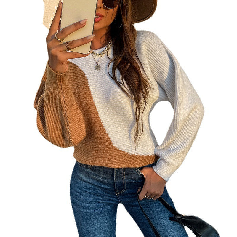 Woman modeling camel and cream color-block knit sweater with long sleeves and relaxed fit