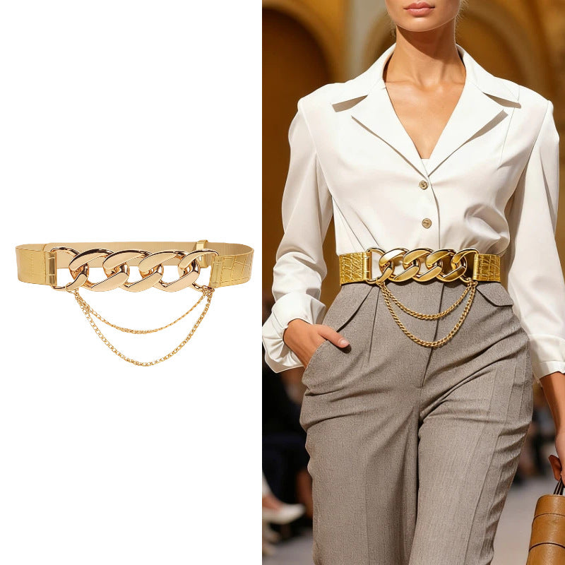 Women’s gold chain elastic waist belt styled over a fitted black dress