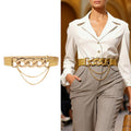 Women’s gold chain waist belt styled with a white blouse and tailored trousers