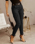 Women's black high-waist slim cargo pants with side utility pockets and tapered ankle fit