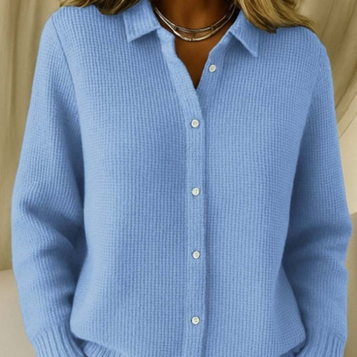 Woman wearing a light blue button-down knit sweater with collared neckline and long sleeves