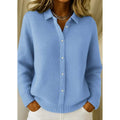 Woman wearing a light blue button-down knit sweater with collared neckline, long sleeves and ribbed hem