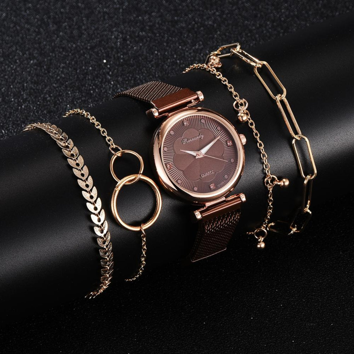 Women's rose gold watch with brown mesh band and coordinating gold-tone bracelet jewelry set