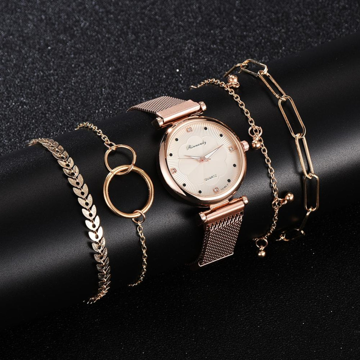 Women's rose gold mesh watch with cream dial and coordinating gold-tone bracelet jewelry set