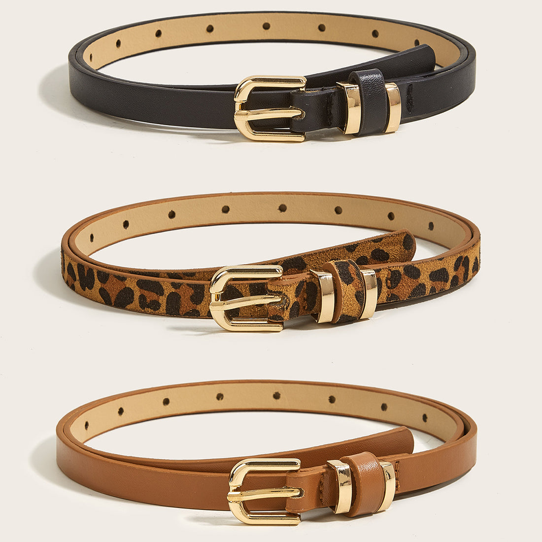 Front view of women’s skinny gold buckle belts in black, leopard print, and cognac brown with gold-tone hardware