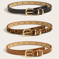 Front view of women’s skinny gold buckle belts in black, leopard print, and cognac brown with gold-tone hardware