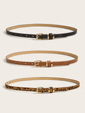 Full view of women’s skinny gold buckle belts in black, cognac brown, and leopard print