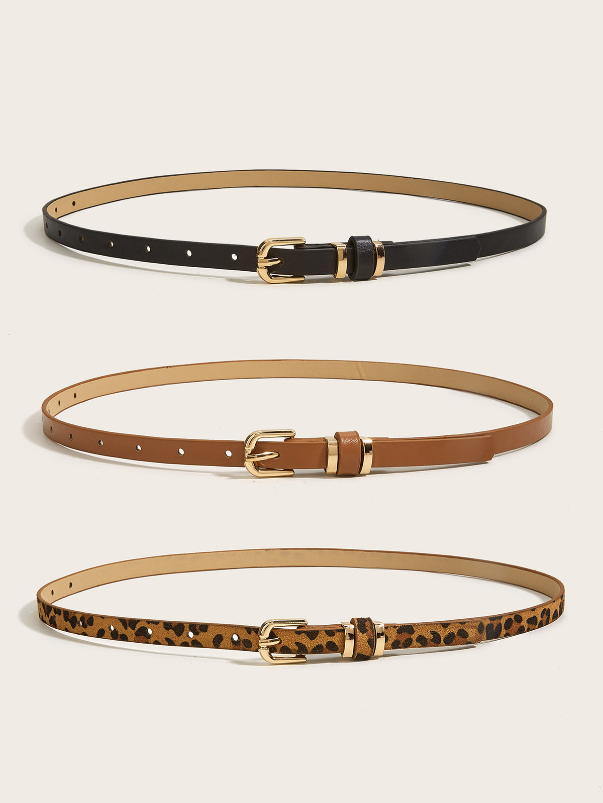 Full view of women’s skinny gold buckle belts in black, cognac brown, and leopard print