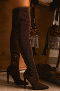 Zaria Bronze Shimmer Over-the-Knee Stiletto Boots worn on a model, featuring a rich deep bronze-brown metallic shimmer finish, fitted thigh-high silhouette, sleek pointed toes, side zipper detail, and elegant slim stiletto heels for a glamorous Fall and Winter statement look.
