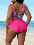 Rear view of a curvy model wearing the Zuri women's two-piece swimsuit on a sandy beach with turquoise ocean waves in the background, featuring a multicolor leopard-print bikini top with straight shoulder straps and a fitted back band, paired with bright hot-pink high-waisted bikini bottoms providing full rear coverage and a smooth, fitted silhouette.
